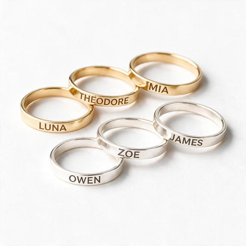 Gold-tone and silver-tone slim stacking rings engraved with different first names.