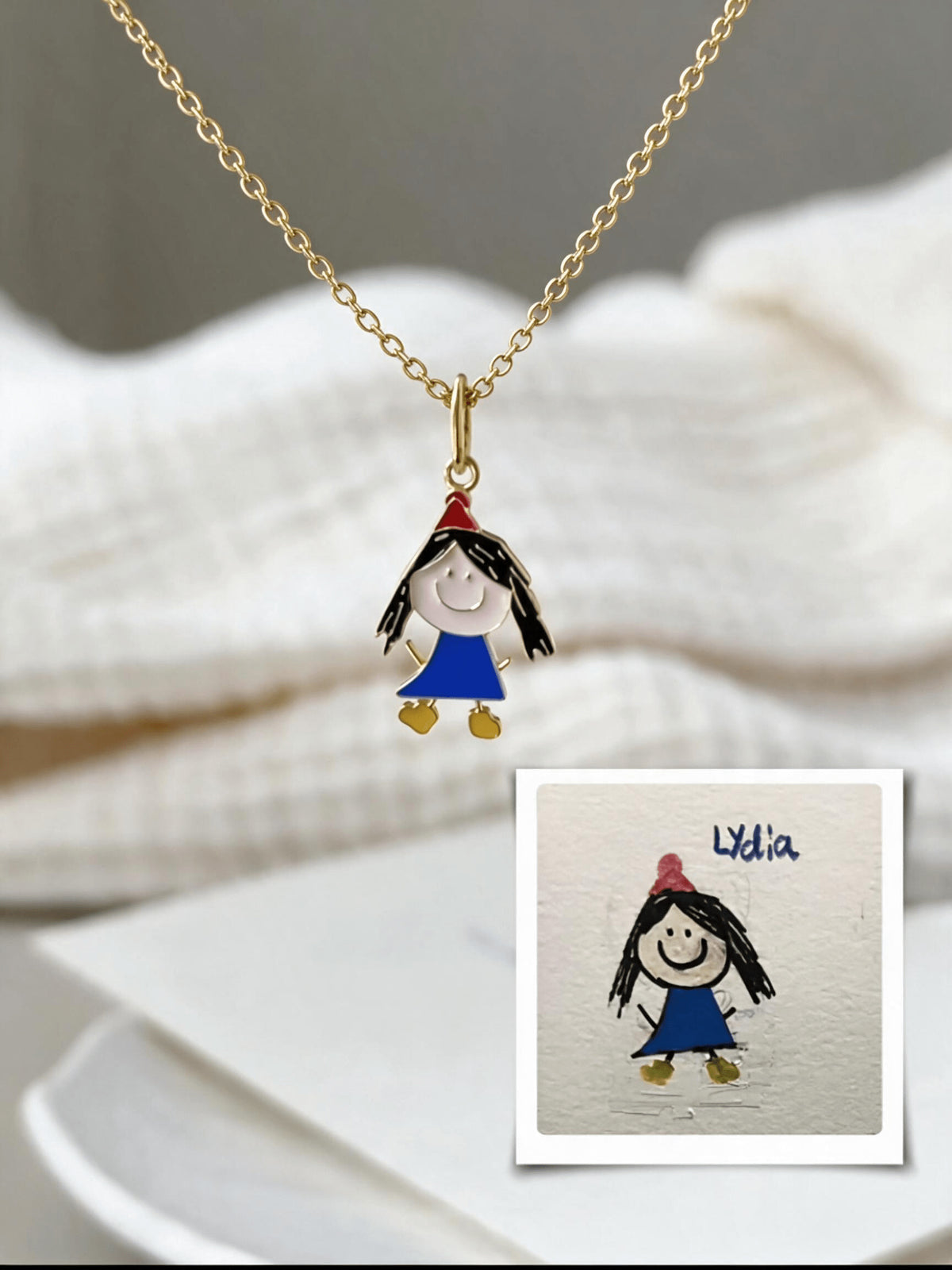 Enamel pendant of a child in a blue dress with the original hand-drawn picture shown below.