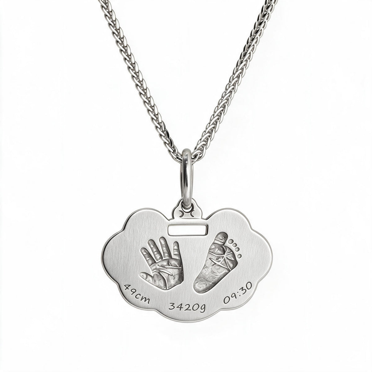 Silver-tone handprint and footprint necklace with sample birth details on the pendant.